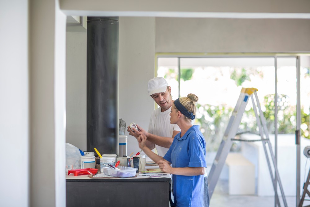 side view of couple standing at kitchen counter